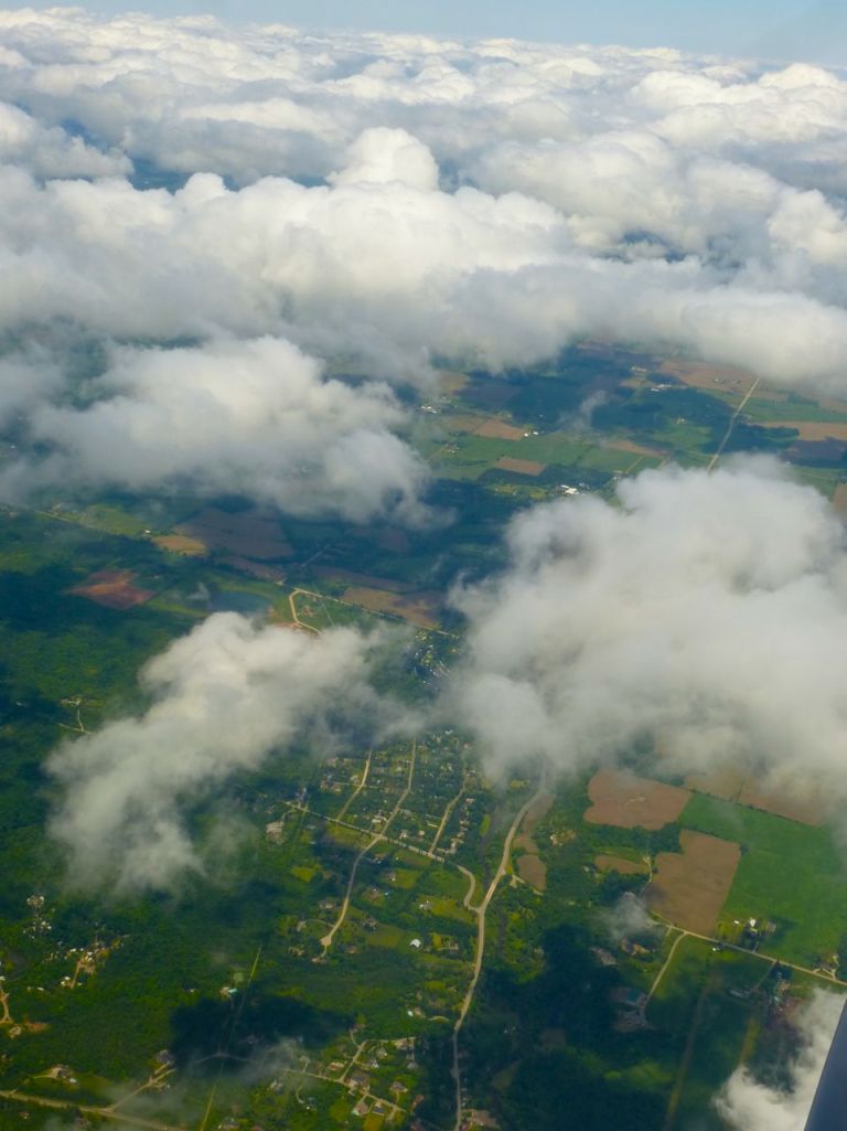 Aerial shot of earth & clouds.